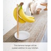 image:imageYamazaki Home Tosca Banana Hanger  Steel  Wood  Elegant banana hanger prevents bruising and keeps fruit fresh longer Durable steel and wood construction Minimalist designWhite